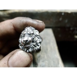 Photographed in the jewellers hands - This silver lions head ring with flowing mane is not just a piece of Irish jewelry - it is a symbol of courage, bravery, and resilience. Whether you're looking for a unique accessory to wear every day or a special gif Photographed in the jewellers hands - This silver lions head ring with flowing mane is not just a piece of Irish jewelry - it is a symbol of courage, bravery, and resilience. Whether you're looking for a unique accessory to wear every day or a special gif