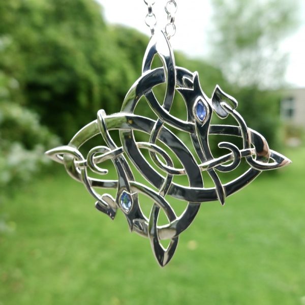 Light passing through blue sapphires. Irish jewellery Dragon pendant Light passing through blue sapphires. Irish jewellery Dragon pendant