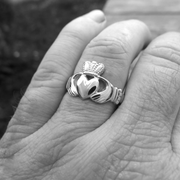 Weathered hands wear a white gold Claddagh ring. A gift that will become an heirloom . The iconic and traditional Irish Claddagh ring. Irish jewellery crafted in Kerry, Ireland Weathered hands wear a white gold Claddagh ring. A gift that will become an heirloom . The iconic and traditional Irish Claddagh ring. Irish jewellery crafted in Kerry, Ireland