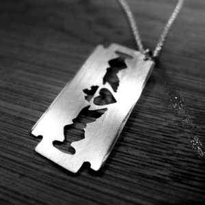 Claddagh Pendant in the shape of a razor. Claddagh necklace in silver.