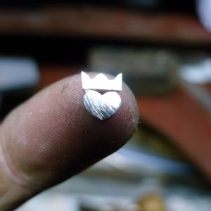 Showing the making of an Irish promise ring. Handcrafted tiny little heart and crown which will be applied to the modern Irish Claddagh ring