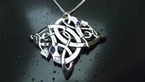 Closeup of Irish jewellery dragon pendant with sapphires
