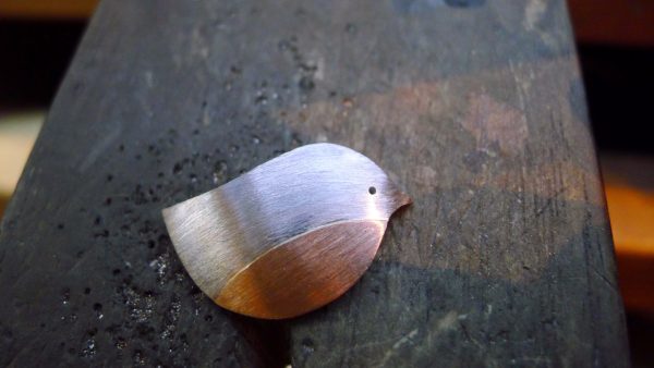 The design is hammered and formed into a flowing shape and a sheet of 10k rose gold is fused to the silver- later a gemstone will be set in the eye The design is hammered and formed into a flowing shape and a sheet of 10k rose gold is fused to the silver- later a gemstone will be set in the eye