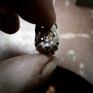 Close up. Crafting a silver wolf pendant