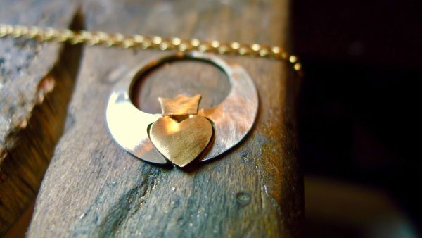 Pure gold heart and crown, handcrafted in the style of a modern Claddagh pendant Pure gold heart and crown, handcrafted in the style of a modern Claddagh pendant