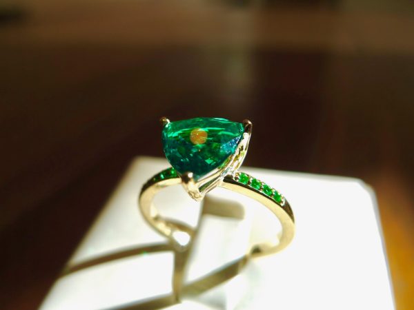 Rich yellow gold holds a trillion shaped emerald . Irish jewellery Rich yellow gold holds a trillion shaped emerald . Irish jewellery