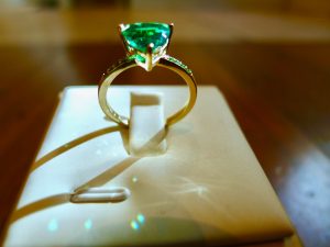 A sunbeam shines through the emerald creating facets of green sparkles A sunbeam shines through the emerald creating facets of green sparkles