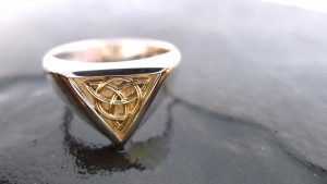 Handcrafted Irish Celtic Ring | Irish Jewellery| Silver and gold Celtic knot ring Photograph of a Handcrafted Celtic ring with an inlaid panel Irish gold