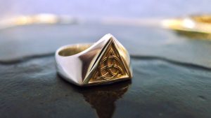 Handcrafted Irish Jewellery Design | Irish Jewellery| Silver Celtic ring with a triangle panel of Irish gold
Photograph of a Handcrafted Irish gold and silver Celtic ring Handcrafted Irish Jewellery Design | Irish Jewellery| Silver Celtic ring with a triangle panel of Irish gold Photograph of a Handcrafted Irish gold and silver Celtic ring