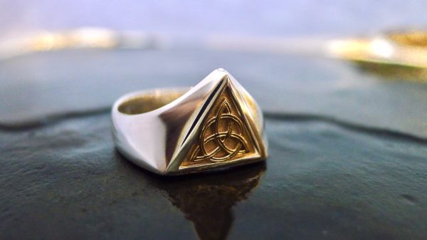 Handcrafted Irish Jewellery Design | Irish Jewellery| Silver Celtic ring with a triangle panel of Irish gold
Photograph of a Handcrafted Irish gold and silver Celtic ring Handcrafted Irish Jewellery Design | Irish Jewellery| Silver Celtic ring with a triangle panel of Irish gold Photograph of a Handcrafted Irish gold and silver Celtic ring