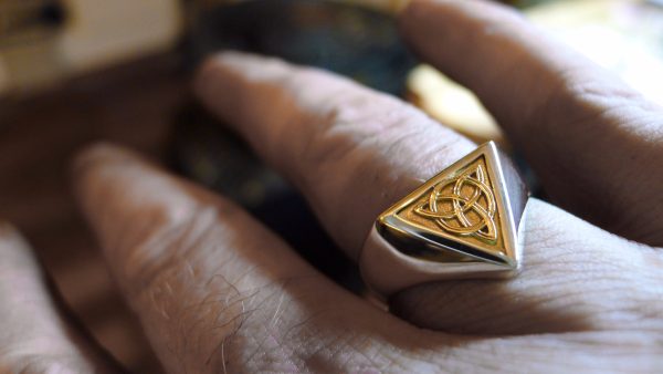 Handcrafted Irish Jewellery Design | Irish Jewellery| Silver Celtic ring with a triangle panel of Irish gold
Photograph of a Handcrafted Irish gold and silver Celtic ring. Handcrafted Irish Jewellery Design | Irish Jewellery| Silver Celtic ring with a triangle panel of Irish gold Photograph of a Handcrafted Irish gold and silver Celtic ring.