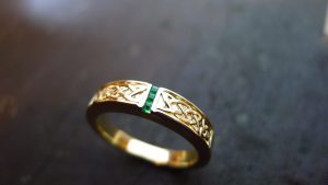 This handmade Celtic ring has two panels of carved Celtic knot work with 3 square gems set deep into the precious metal, giving the piece a flash of colour. Please allow 4 weeks for delivery of your newly crafted irish jewellery