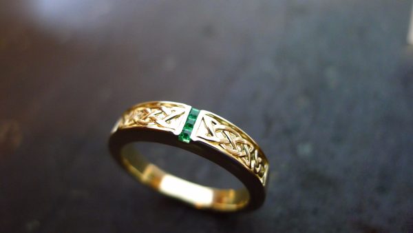This handmade Celtic ring has two panels of carved Celtic knot work with 3 square gems set deep into the precious metal, giving the piece a flash of colour. Please allow 4 weeks for delivery of your newly crafted irish jewellery