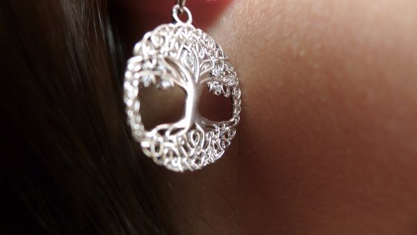 Silver tree of life earrings catching the light. Irish jewellery design at its finest Silver tree of life earrings catching the light. Irish jewellery design at its finest
