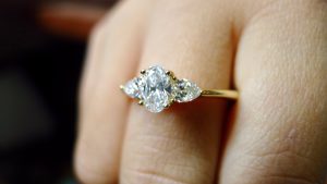 Oval diamond framed by two pear shaped diamonds