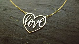 Irish jewellery crafted into the form of a heart with delicate calligraphy